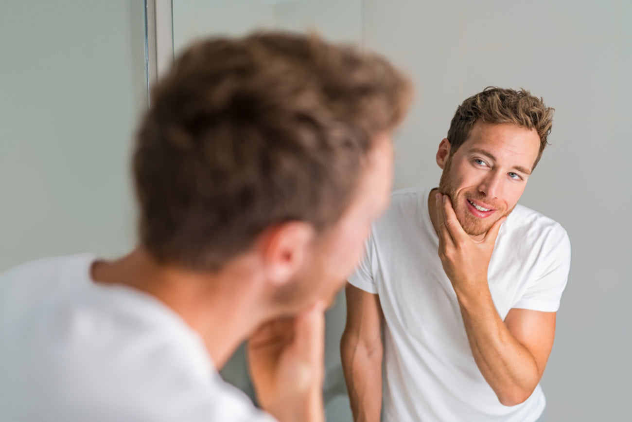 Man looking at skin