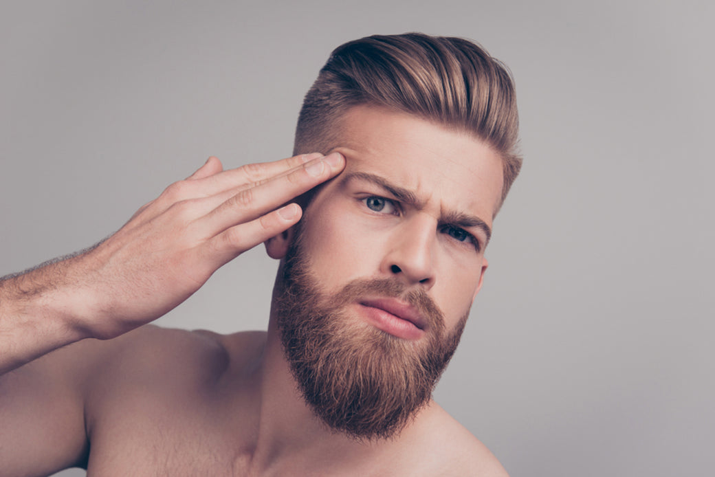 a man inspecting his face