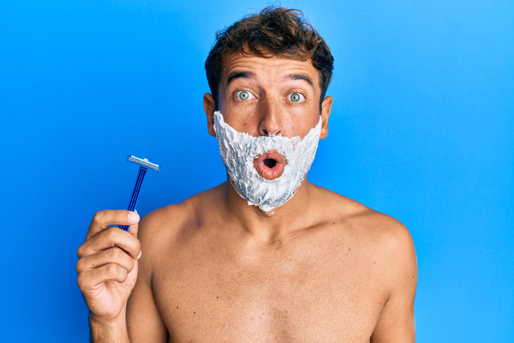 man shaving beard