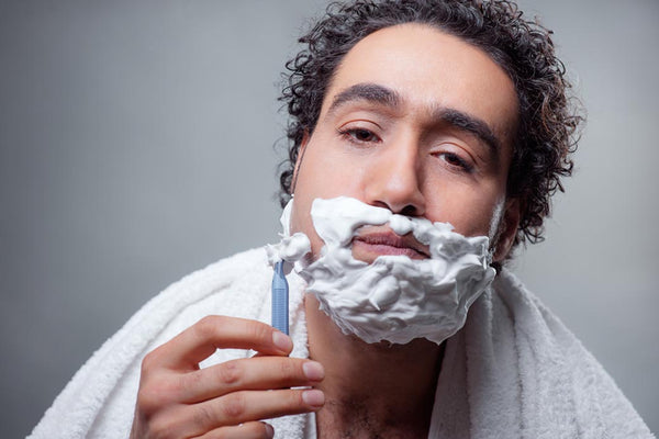a man shaving his face