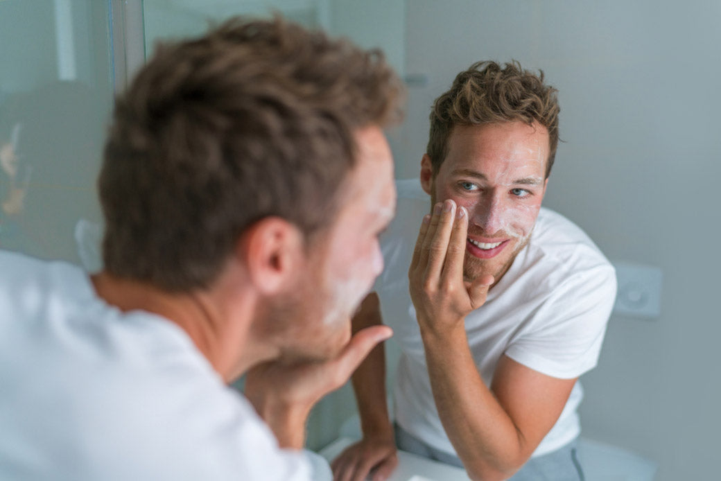 man washing his face