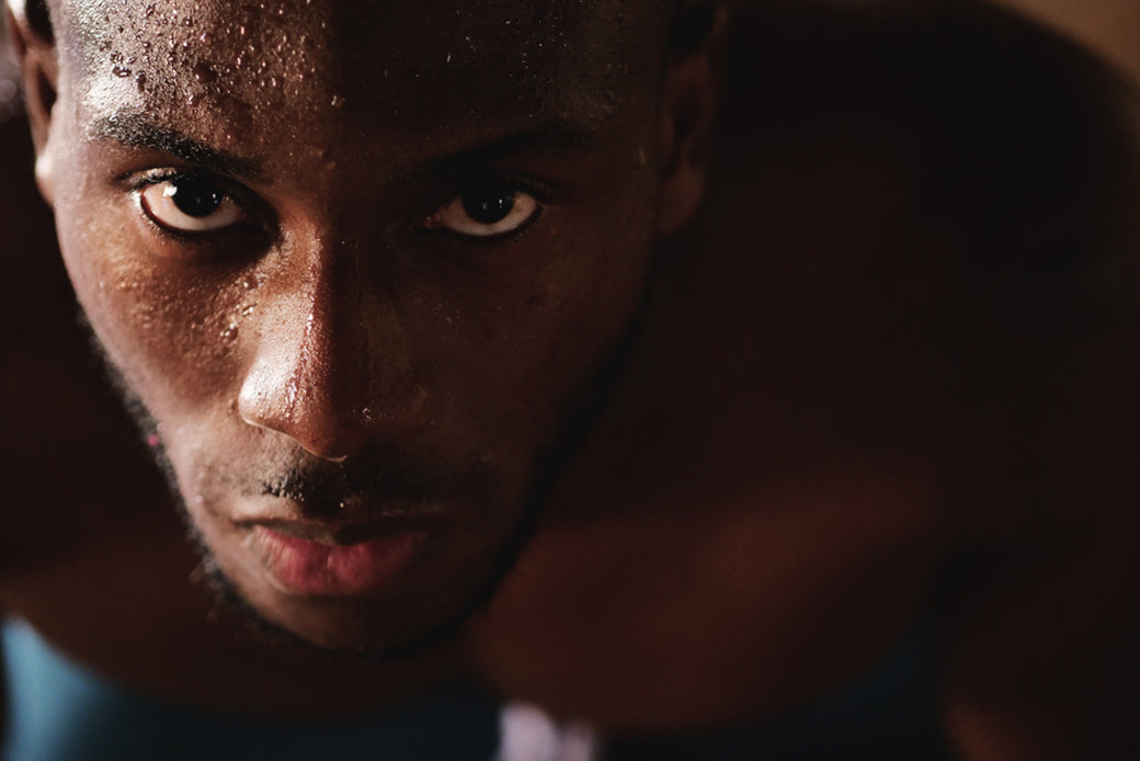 a close up of man with perspiration on his forehead