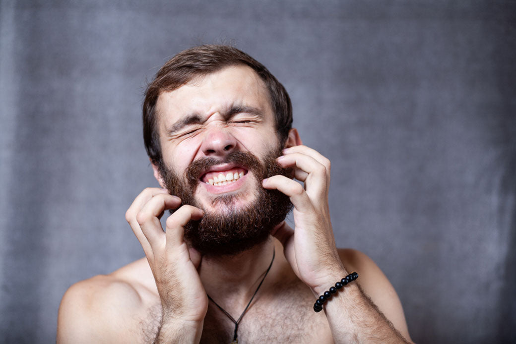 portrait man scratching beard